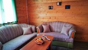 salon z 2 kanapami i stołem z misą owoców w obiekcie Wooden House "Una" w mieście Kulen Vakuf