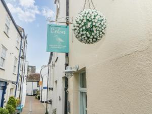 a sign for a restaurant on the side of a building at Curlews Cottage in Looe