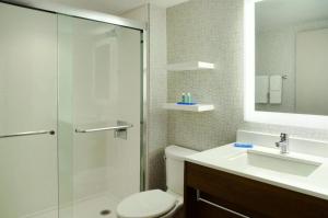 a bathroom with a shower and a toilet and a sink at Holiday Inn Express Toronto Downtown, an IHG Hotel in Toronto