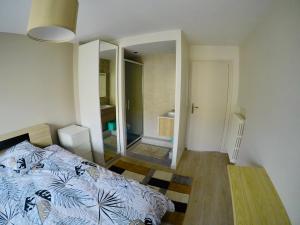 sypialnia z łóżkiem i dużym lustrem w obiekcie Charming & cosy rooms Nantes (chambres chez l'habitant) w mieście Nantes
