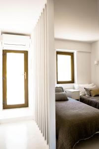 a bedroom with two beds and a window at Beach House Pedras D'el Rei in Santa Luzia +63 photos