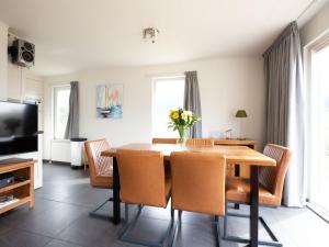a dining room with a table and chairs at Holiday Home in De Koog near Texel Beaches in De Koog