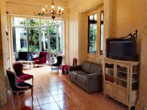 a living room with a couch and a tv at Best Western Central Hotel in Tours