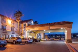 a gas station with cars parked in a parking lot at Best Western Plus John Jay Inn & Suites in Palmdale