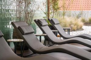 a row of empty chairs in a patio at Casas Da Lapa, Nature & Spa Hotel in Seia