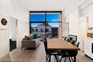 a living room with a table and a couch at Penthouse Leisure in Queenstown