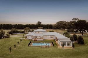 an aerial view of a large house with a pool at The Pines Barwon Heads in Connewarre