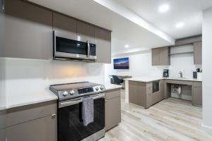 a kitchen with a stove and a microwave at Wiggins Pass Chalet in Naples