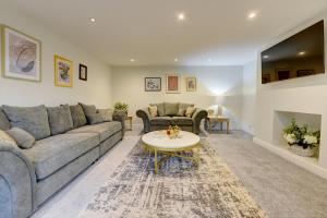 a living room with a couch and a table at Kist Accommodates - The Woodlands in Harrogate