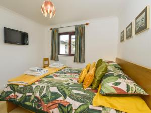 a bedroom with a bed and a tv on the wall at 24 Burgh Island Causeway in Bigbury on Sea +18 photos