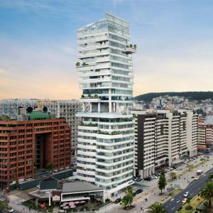 a tall white building in a city with buildings at Hermoso Penthouse Vistas Espectacular in Quito