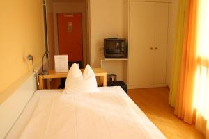 Rúm í herbergi á Seminar-Hotel Rigi am See