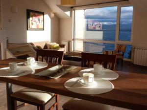 a dining room table with two hats and cups on it at Civico Apartment in San Carlos de Bariloche
