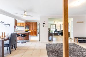 a kitchen and living room with a table and chairs at Willows At The Bay Large House with Aircon WI-FI and Boat Parking in Shoal Bay