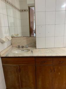 a bathroom with a sink and a mirror at Hostel la Embajada in Mendoza