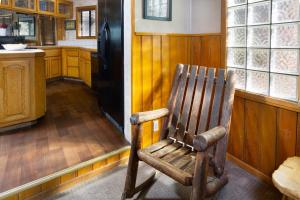 a wooden rocking chair sitting in the middle of a kitchen at Lake Shore Family Cabin w Hot Tub and Pool Table by Big Bear Vacations in Big Bear Lake +15 photos