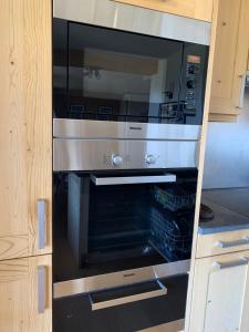 a microwave oven sitting inside of a kitchen at Route de la Résidence in Villars-sur-Ollon