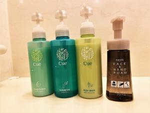 a group of four different colored bottles on a counter at Hotel Route-Inn Hakata Ekimae -Hakataguchi- in Fukuoka +56 photos