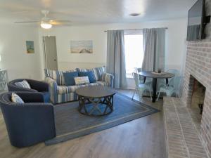 a living room with a couch and a table at Saltaire Cottages in Kitty Hawk Beach