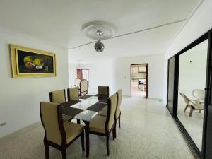 a dining room with a table and chairs at MADILI DEL MAR in Santiago