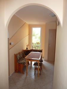 a dining room with a table and a couch at Penzion Čech in Valtice