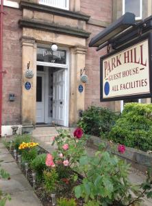 a pink hill guest house with a sign in front of it at parkhill guest house in Inverness