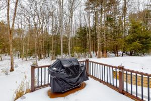 a black garbage bag on a wooden railing in the snow at Juniper Grove & Evergreen Terrace in Ogunquit +2 photos