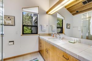 a bathroom with a sink and a mirror at The Indigo in Sea Ranch +42 photos