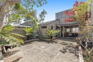 an exterior view of a house with trees at The Indigo in Sea Ranch