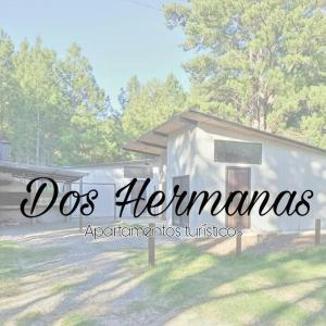 a small white building with the words dogs heinemann on it at Apartamento Dos hermanas in Colonia Estrella