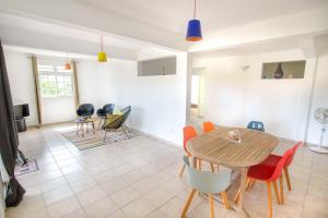 a dining room and living room with a table and chairs at BED AND COFFEE PLAGE in La Trinité