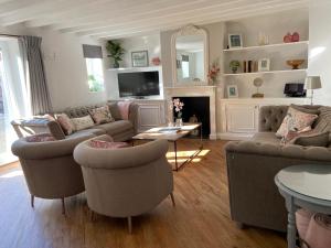 a living room with two couches and a fireplace at The Granary in Bedford