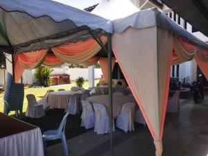 a group of tables and chairs under a tent at Prairie Villa Homestay in Lumut