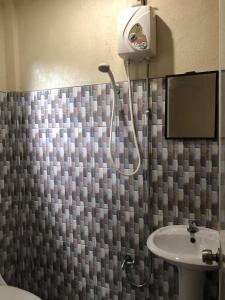 a bathroom with a shower and a sink at AMK traveller's hub in Maite +38 photos