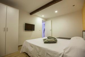 מיטה או מיטות בחדר ב-Cortile Antico