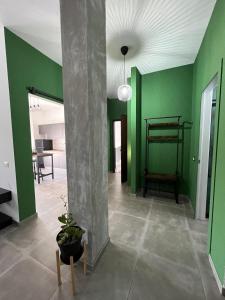 uma sala de estar com paredes verdes e um pilar em Appartamento Calilla em Taranto