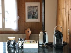 a counter top with a coffee maker and a microwave at Chalet Pironnet with BEST Views, Charm and Comfort! in Lauterbrunnen