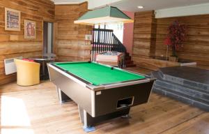 a pool table in a room with wooden walls at Spacieux 4/6 places proche du centre in Saint-Lary-Soulan