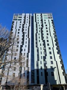 a tall building with a blue sky in the background at Tallinn Center Apartment in Tallinn