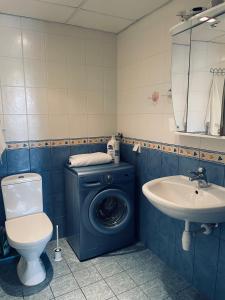 a bathroom with a washing machine and a sink at Tallinn Center Apartment in Tallinn