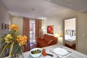 a living room with a couch and a table at Apartamentos Murillo in Seville