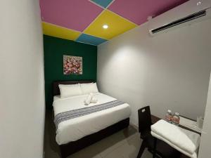 Postel nebo postele na pokoji v ubytování Cassia Inn Kuching + 9 fotografií