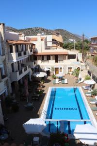 a hotel with a swimming pool in front of a building at Apollo City Hotel - Maliatim in Malia