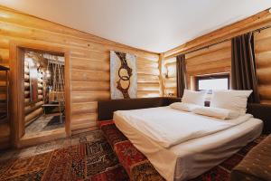 a bedroom with a bed in a room with wooden walls at Inn OZZ in Karagandy +119 photos