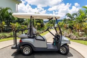 a golf cart with a surfboard on top of it at Anchorage in Hamilton Island