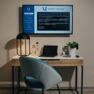a desk with a chair and a laptop on it at Amery House in Sliema