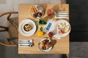 a wooden table with plates of food on it at Amery House in Sliema