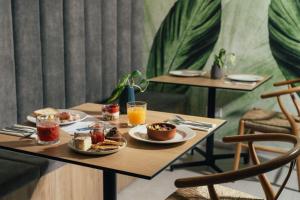a table with plates of food and drinks on it at Amery House in Sliema