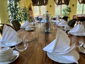 a long wooden table with glasses and napkins on it at Fuchs'sche Mühle in Weinheim