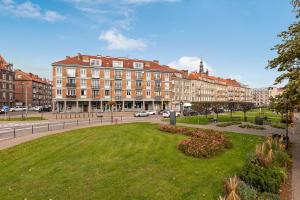 a large building with a park in the middle of a city at Ideal Apartments Arkady in Gdańsk